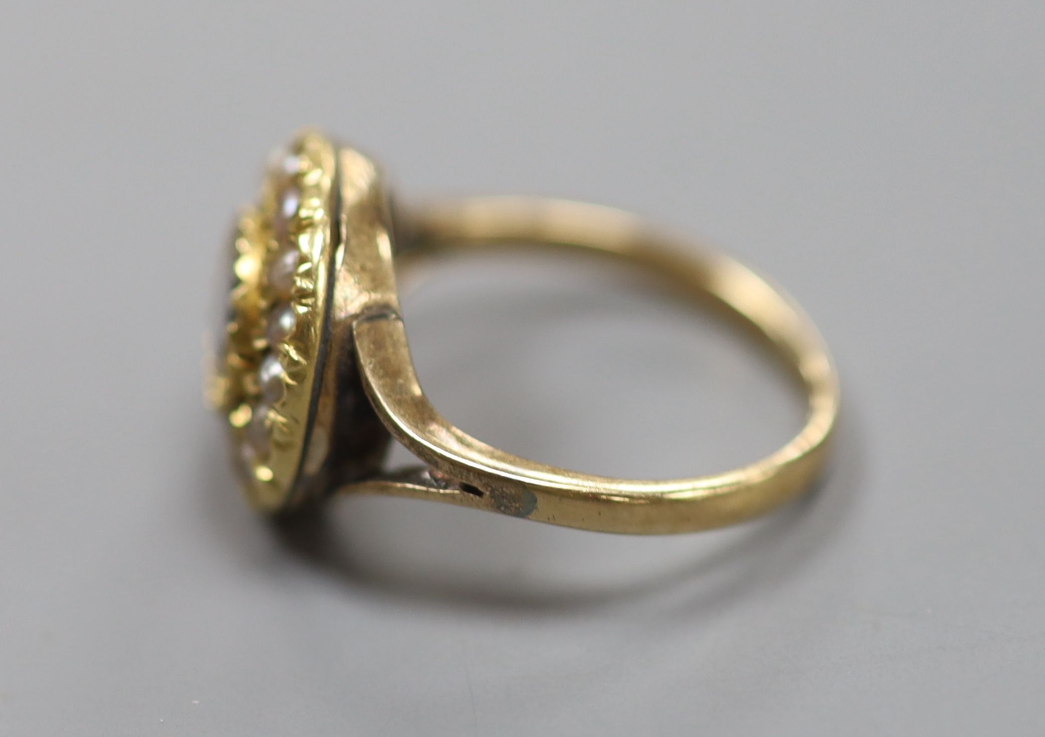 A 9ct, citrine and seed pearl set circular cluster ring